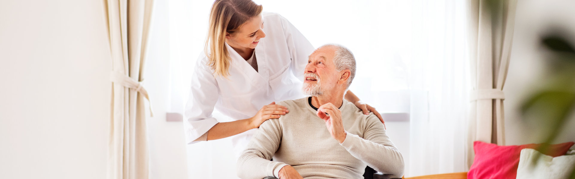 caregiver and senior man in the living room